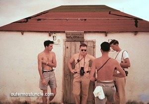 A group of Cold War Radar tracking station employees hanging around in front of a bar. 1950's Bahamas.