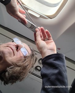 Marcy, photographing out the window of an airplane over the Bahamas, in the Bermuda Triangle, using my uncle's vintage Minox IIIs spy camera.