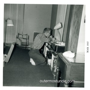 Vintage 1950's black and white photo. Uncle Bill eating over his stereo equipment. Archbold, Ohio.