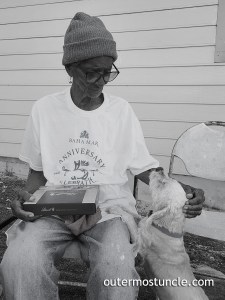Juanita Vernecia Benson and Teddy, her dog. Victoria Hill, San Salvador Island. Bahamas. February, 2024.