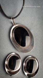 A mid century modern necklace and earrings set. Black coral set in silver.