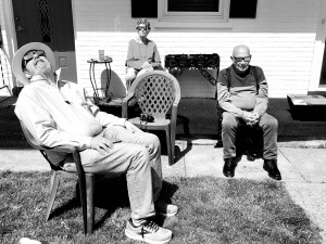Three people, in black and white, experiencing the total solar eclipse.