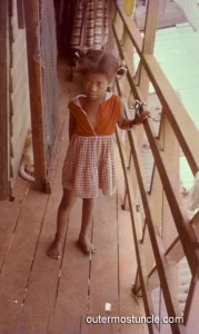 Bahamian girl on a porch. 1950's.