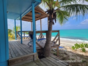 A view across the porch to a lovely tropical beach. San Salvador Island, 2025.