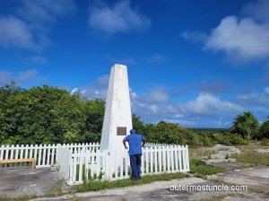 The monument to a Thir missile launch. Huel Williamson reads the plaque. Mayaguana, Bahamas.