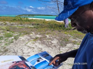 Huel points his finger to a page in my uncle's picture book.