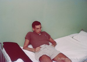 Donald Diehl, slumped back on a bed, probably in a dorm room.