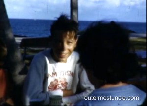 A boy at a picnic table.