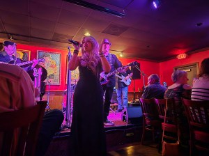 A photo in a nightclub of a Fleetwood Mac tribute band performing.
