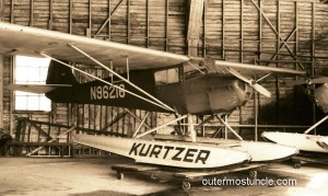 A sepia tone photo of an old seaplane in a hangar on Lake Union in Seattle, WA.