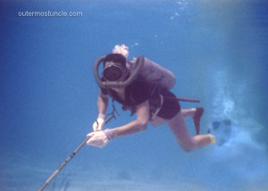 Photo of a diver with aqua lung, mask and spear gun.