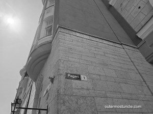 Black and white photograph, looking up at an imposing Cold War era building.