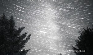 The night sky with Milky Way and star tracks.