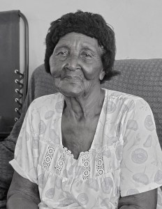 Laura McFee. Mayaguana's oldest person, sitting in her living room.